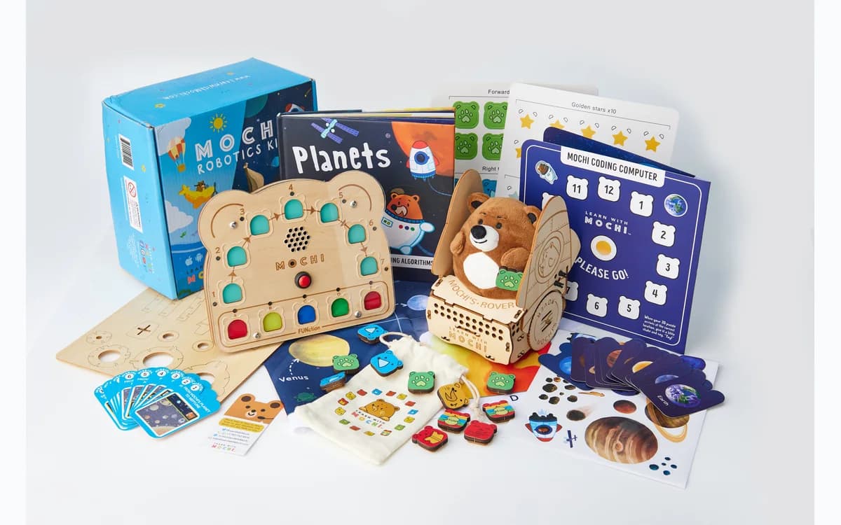 Child arranging physical code blocks on the Mochi programming board