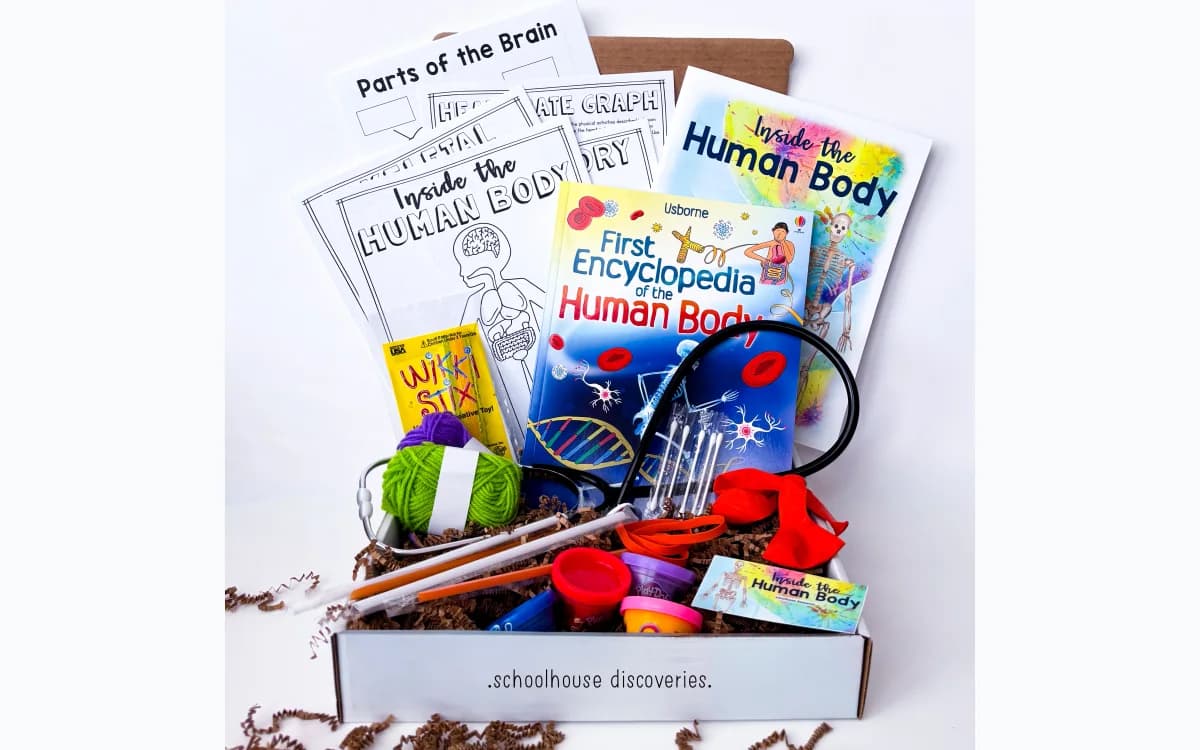 The books, guide, activity pages, and supplies inside a Schoolhouse Discoveries kit