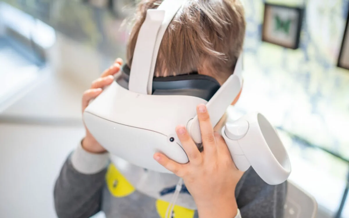Homeschool student wearing a VR headset exploring a VictoryXR VXRLabs experience